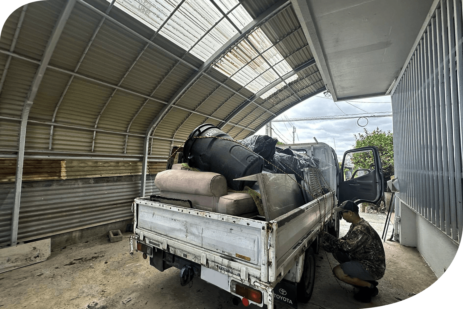 ZE OKINAWA crew loading a full truck of bulky trash